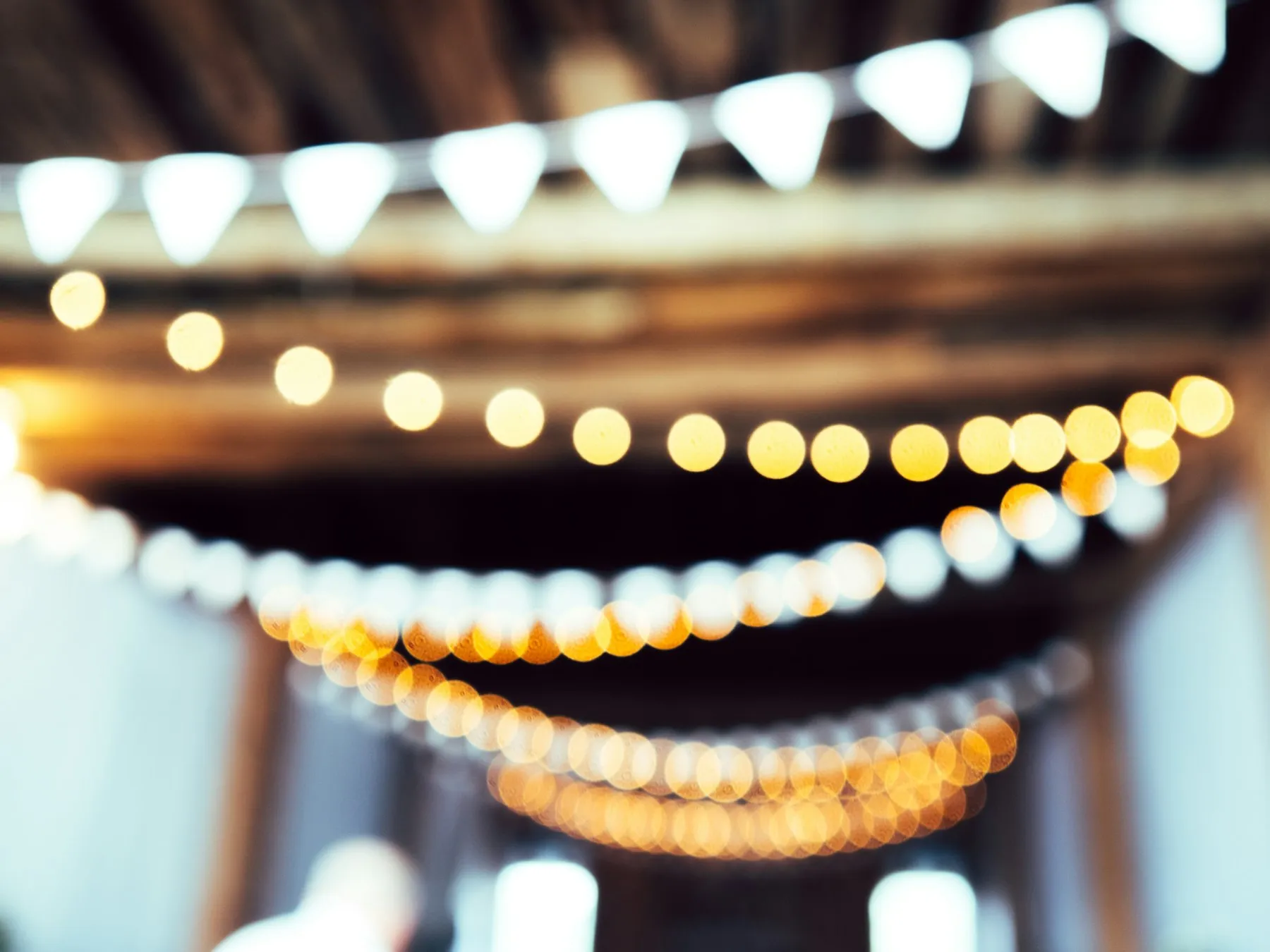 Warm string lights and bunting at an event venue