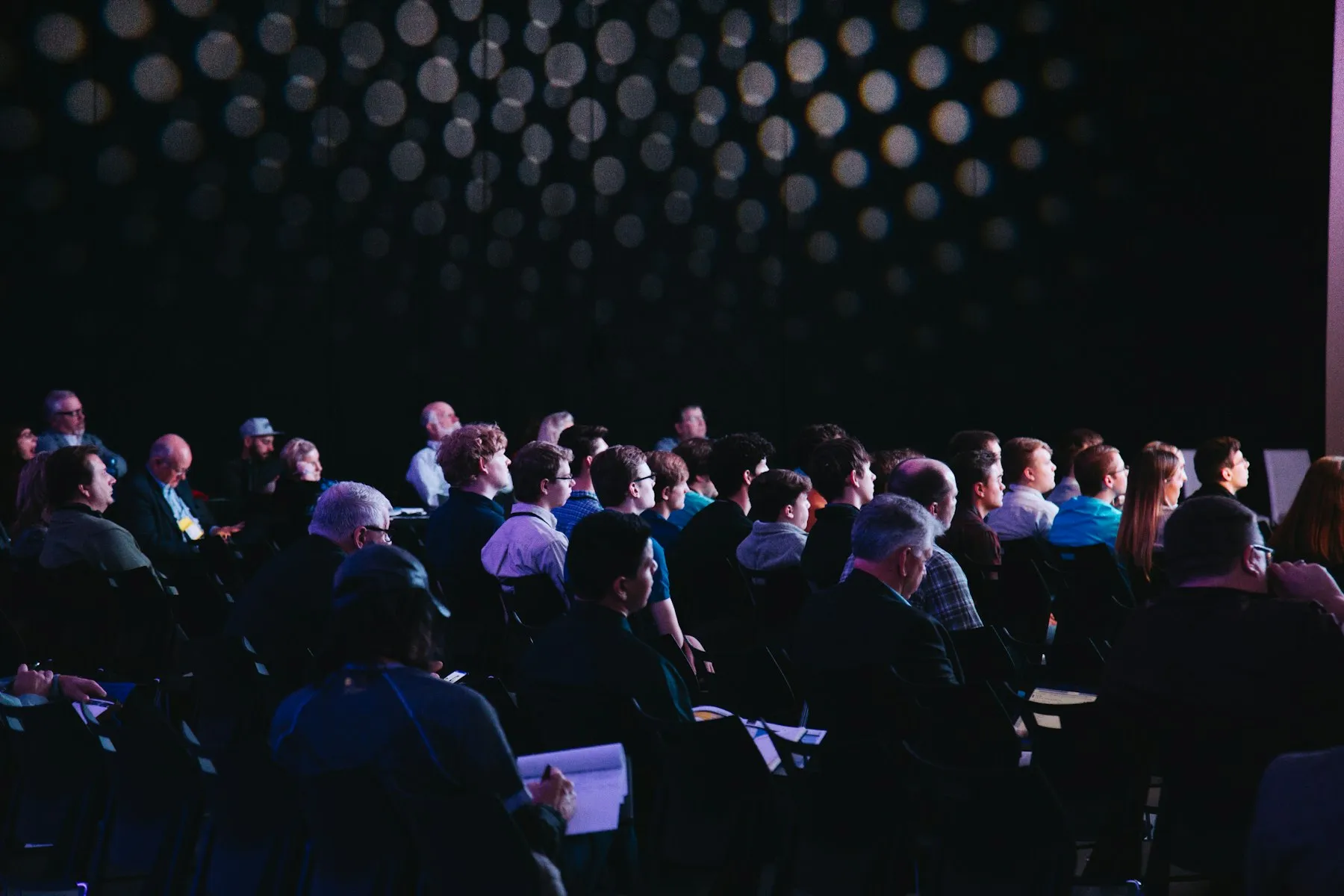 Audience at a conference under soft lights